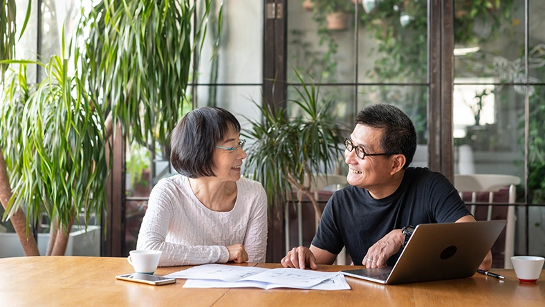 Older adult reviewing finances at home, representing rebuilding retirement savings and financial planning.