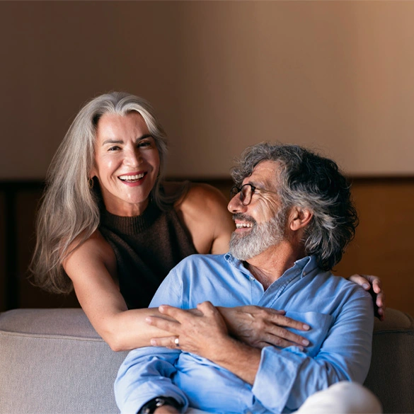 Two adults spending time together at home, illustrating long-term savings growth and financial security.