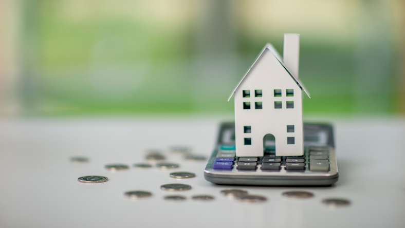 Model home on top of a desk calculator.