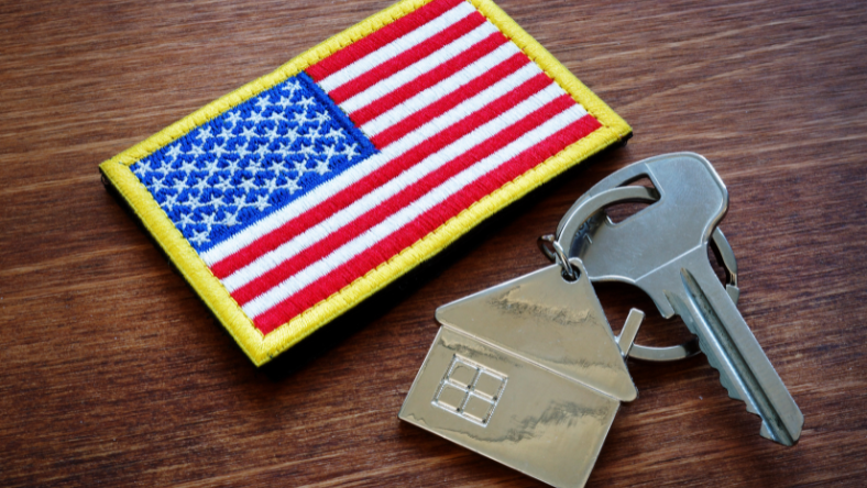 USA flag patch next to a set of keys to a home.