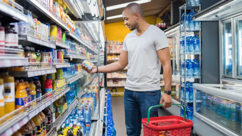 Young man shopping at a grocery store.