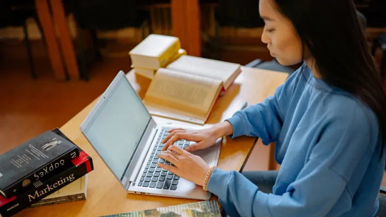Young woman typing on laptop.
