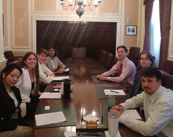 Seven Salem Five interns sitting in the board room.