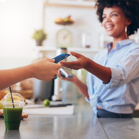 Woman paying for drink with Salem Five debit card.